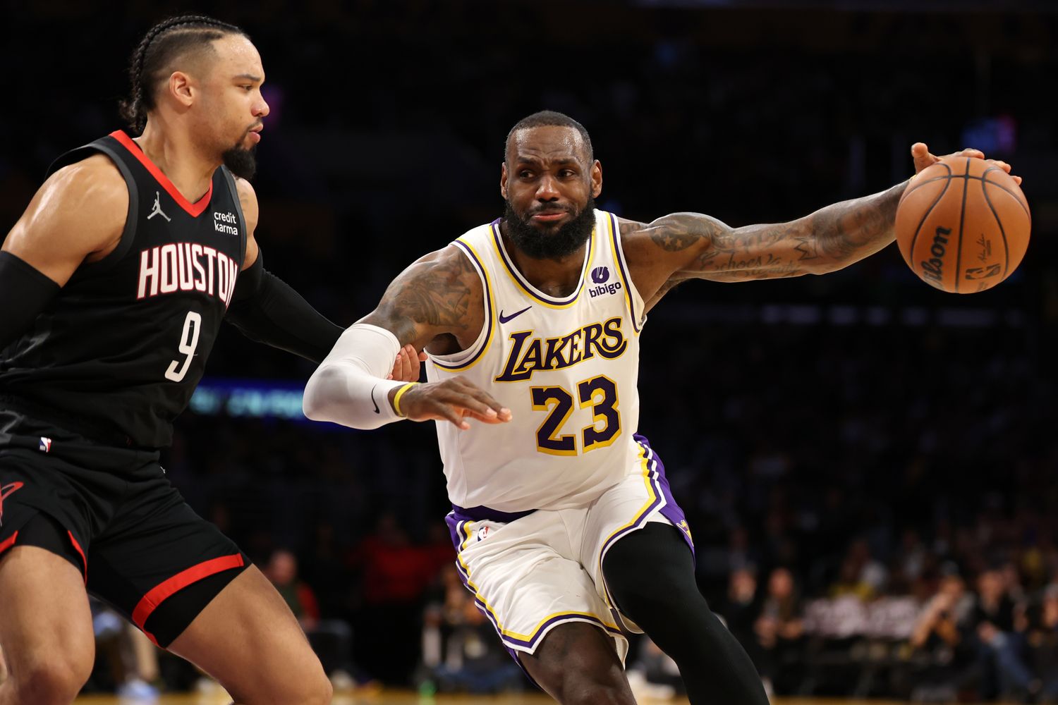 Lakers forward LeBron James (23) dribbles against Houston Rockets forward Dillon Brooks (9) during the second quarter at Crypto.com Arena.